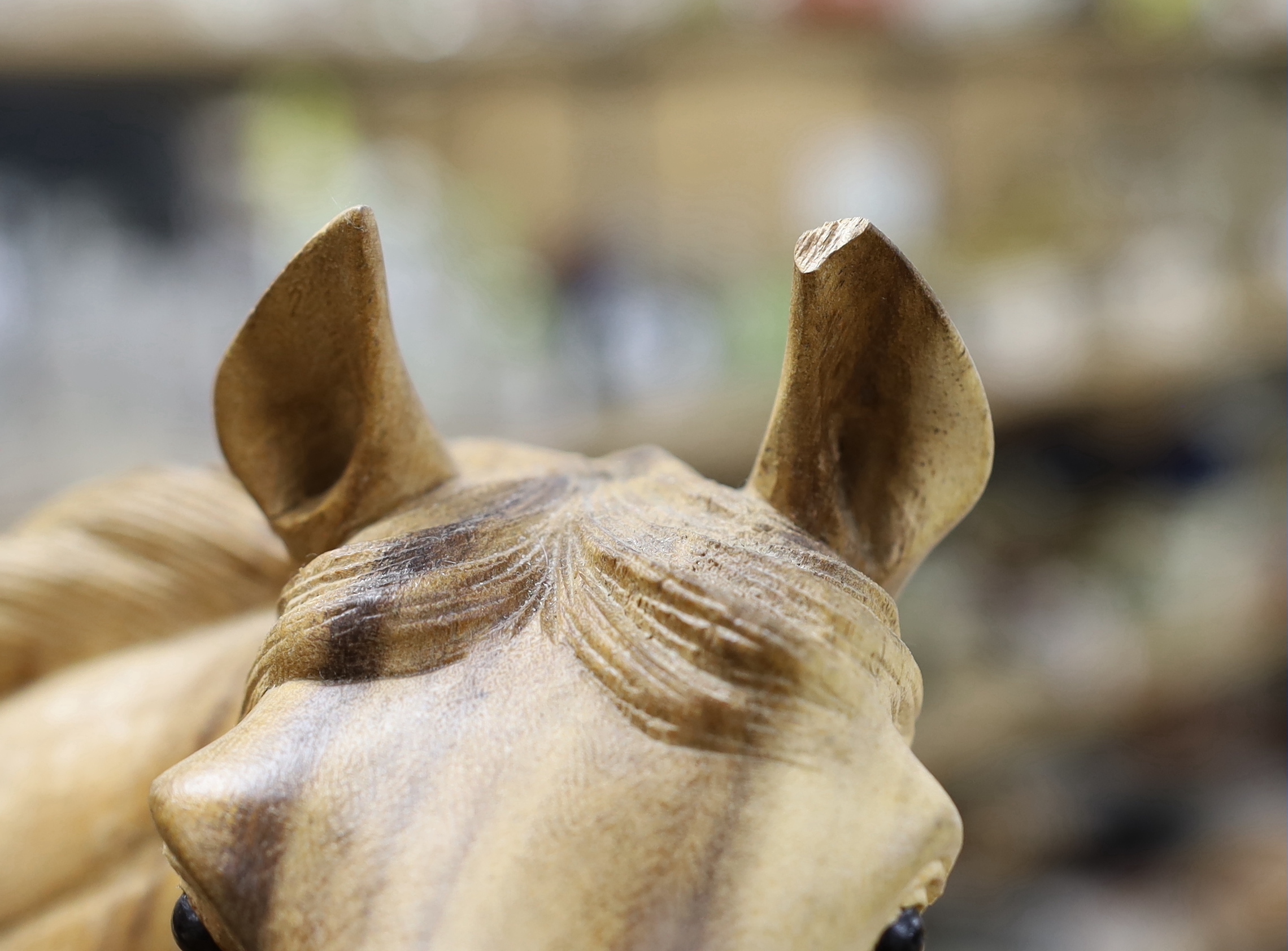 A large wooden carving of a horse and foal, 70cm wide